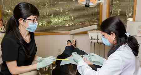Who performs cosmetic dentistry and what are the education requirements?