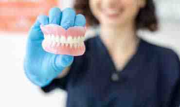 How do you keep dentures in place without adhesive?