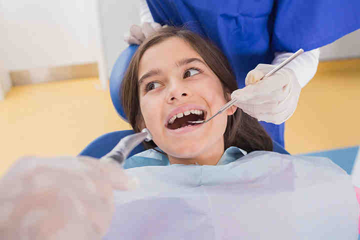 For which set of patients does a pediatric dentist focus on providing oral healthcare?