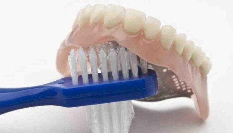 Can you brush dentures with toothpaste?