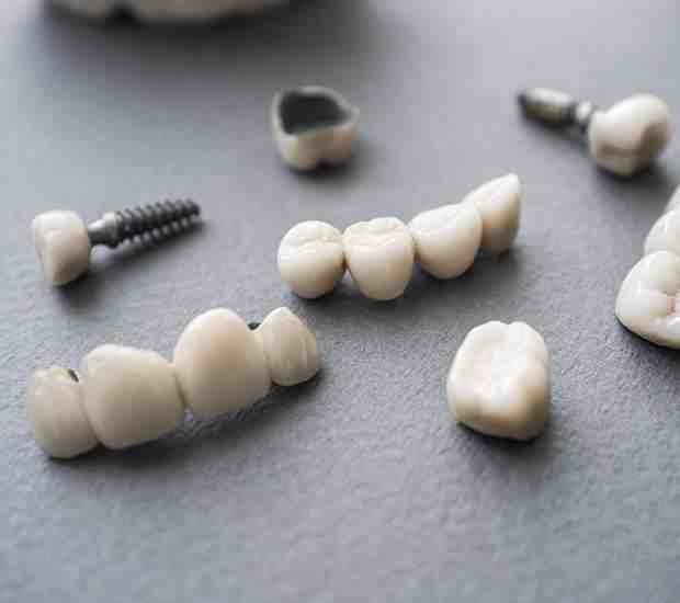 Why does my dental implant hurt when I chew?
