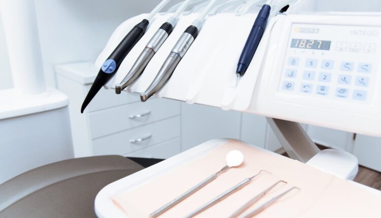 Modern dental equipment and tools arranged on a tray in a dentist's office.