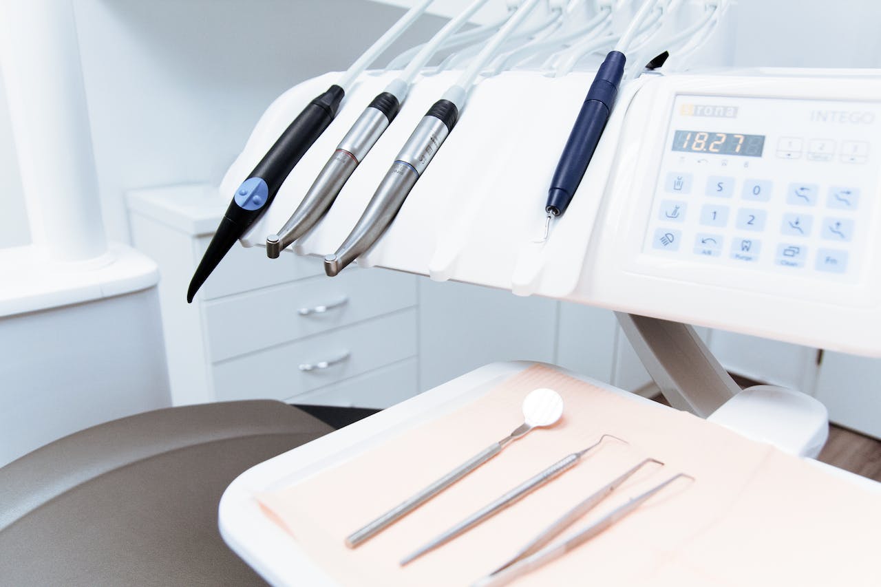 Modern dental equipment and tools arranged on a tray in a dentist's office.